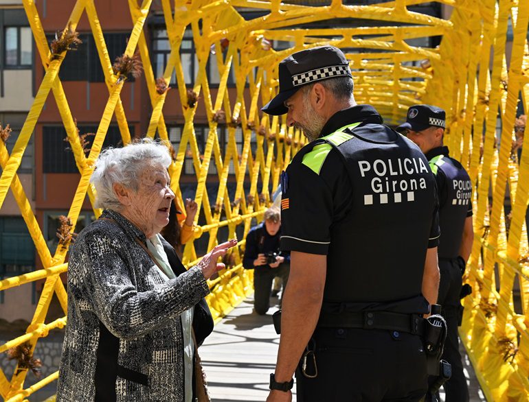Agente de la Policía Municipal de Girona atendiendo a una ciudadadana de la tercera edad.